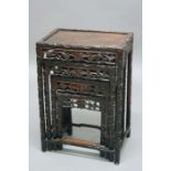NEST OF FOUR CHINESE HARDWOOD TABLES, carved scrolling vine borders and pierced aprons, height 71cm,