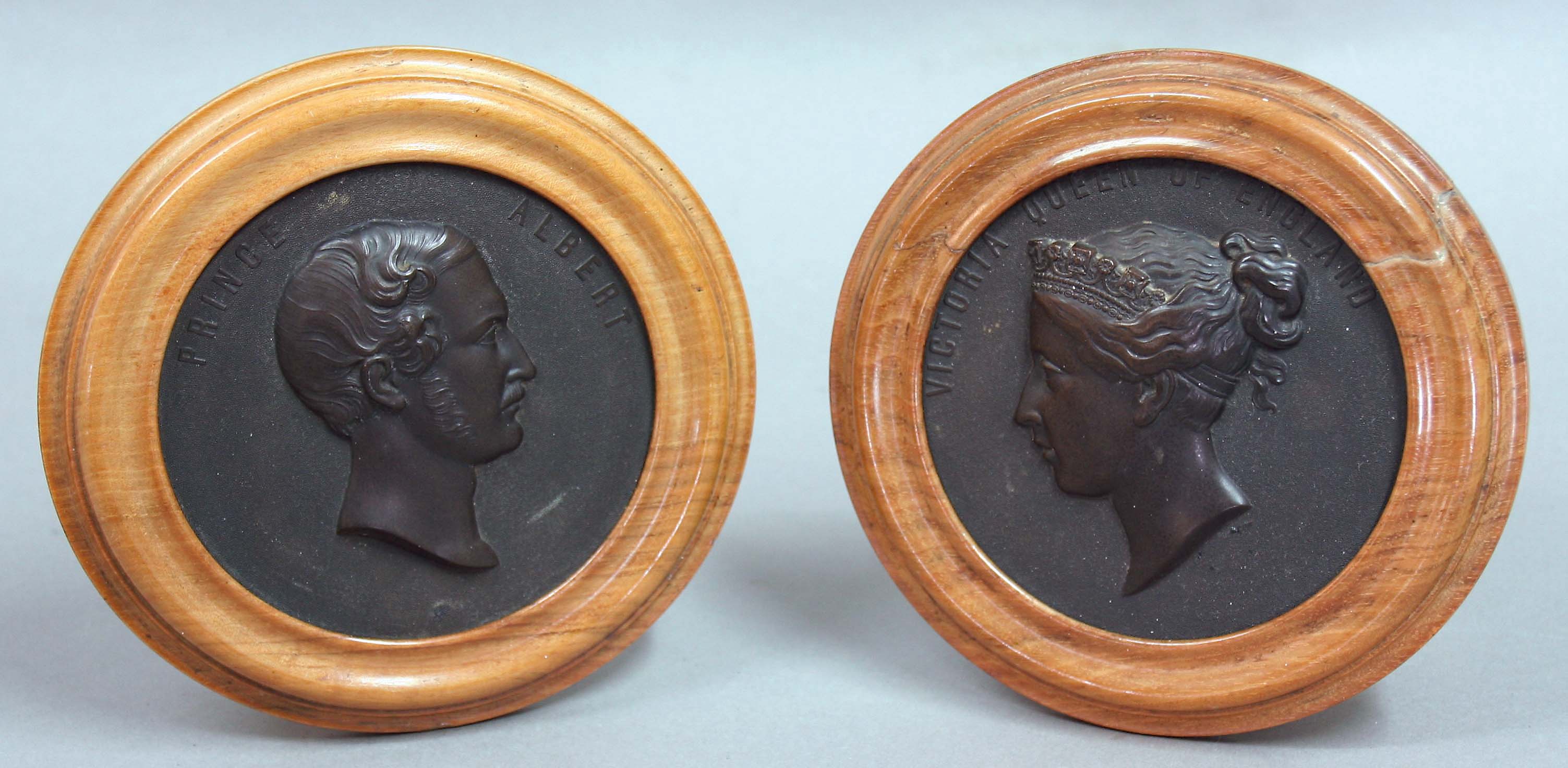 PAIR OF BOIS DURCI COMMEMORATIVE PLAQUES, with profile bust portraits of Prince Albert and