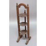 SINO-INDIAN HARDWOOD FOLDING CAKE STAND, three tiers, the frame and rims carved with Chinese dragons