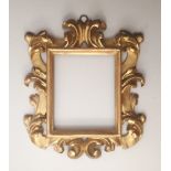 A 19th CENTURY ITALIAN PICTURE FRAME with boldly carved and gilded scrolls and leaves To fit