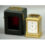 GILT BRASS FOUR PANE CARRIAGE CLOCK, the enamelled dial on an eight day brass movement half hourly