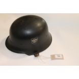 A GERMAN HELMET. A WW11 style German Police Helmet with double decals, in black finish. Tan liner