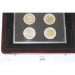 A CASED COIN SET. A Westminster mint set of (7) cased cupro-nickel Crowns with gold embellishments