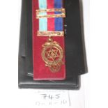 A GOLD MASONIC AWARD. A Hallmarked 9ct Spencer of London cased award, with top and bottom ribbon