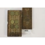 A 17thC CARVED CASE FOR COIN WEIGHTS. A carved 17thC coin weight case inlaid with MOP and