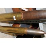 ARTILLERY SHELLS. Two large artillery shells one with explosive head standing 27.1/2" high, 3" dated