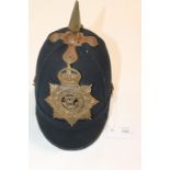 A SOMERSET LIGHT INFANTRY CLOTH HELMET. A blue cloth post 1902 pattern spike helmet, with