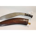 A KUKRI & DAGGER. An unusual Kukri with metal swirl grip hilt and carved wooden scabbard. The
