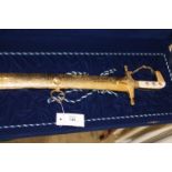 A CASED MIDDLE EASTERN PRESENTATION 20thC SWORD. A 1970's period Shamshir sword with ornate gilt