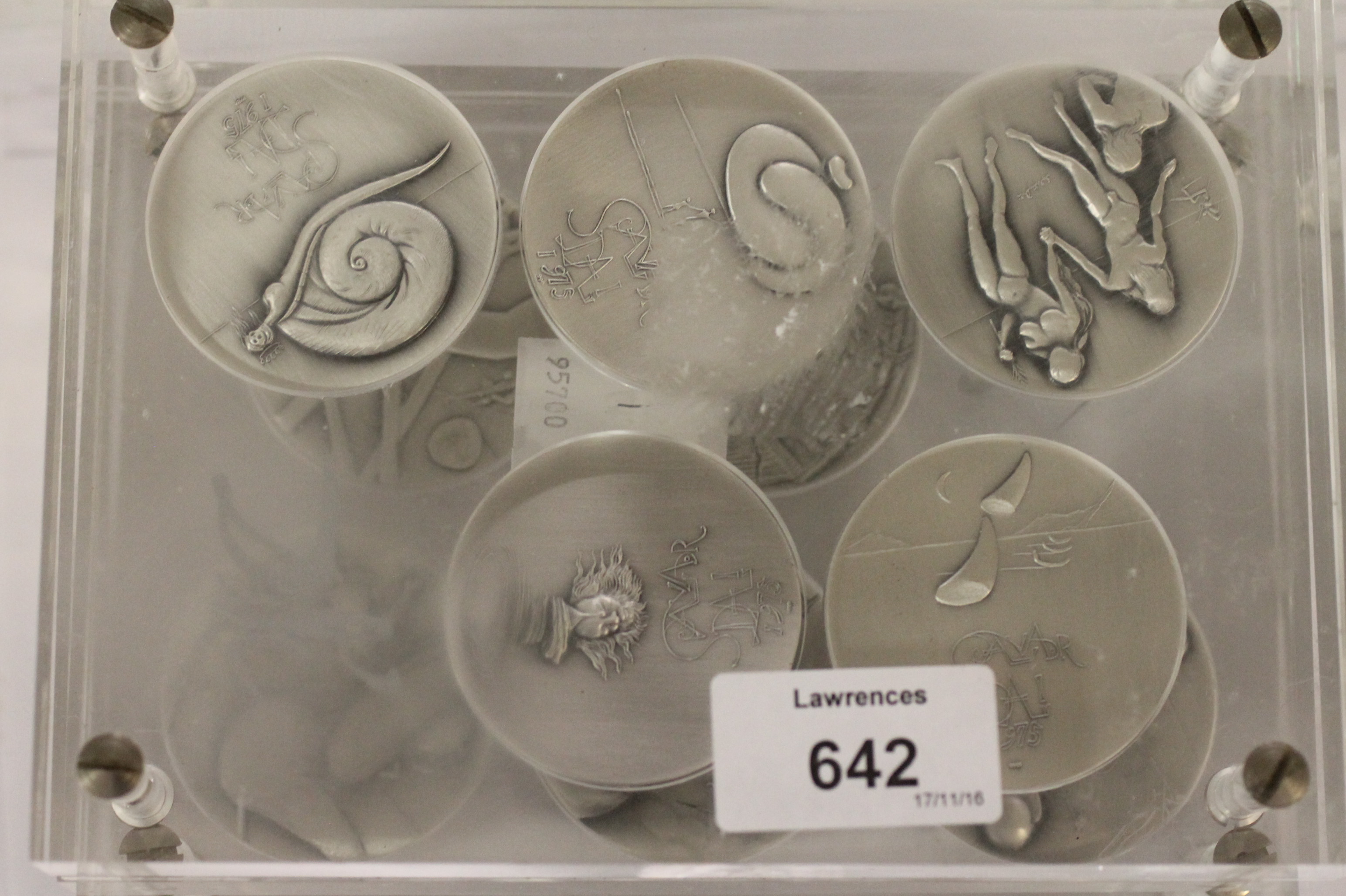 CASED SALVADOR DALI SILVER MEDALLIONS. (10) Acrylic cased Salvador Dali medallions with 1975 and