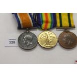 A DEVONS TFWM GROUP OF THREE MEDALS. A Territorial Force War Medal named to 371 Pte J H Selway Devon