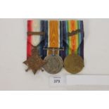 A GRENADIER GUARDS OFFICERS STAR/BAR & MID TRIO. A 1914 Star with Bar named to Lieut T E R Symonds