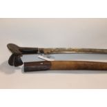 A YATAGAN SWORD. A Yatagan sword with wooden flared pommel, brass mounts with 23.3/4" blade. Some
