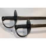 A BRACE OF CUTLASSES Two 19thC naval cutlasses with iron hilt guards and carved wooden grips. 29.1/