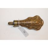 A POWDER FLASK. A brass and copper Powder Flask with ornate decoration and makers name, G & J W