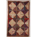 AN EARLY C20TH PATCHWORK QUILT Stripes of colourful patchwork in squares, surrounded with a wool