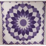 A DOUBLE QUILTED PATCHWORK BEDCOVER White and purple patch worked quilt, with scalloped edge. Good
