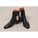 A PAIR OF LEATHER BOOTS Black leather suit boots, Made in Italy. Zip at side, wooden shoe trees. 1.