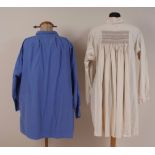 AN EMBROIDERED COTTON SMOCK AND DARK BLUE SMOCK. Oatmeal cotton smock with smocking front and