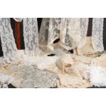 A BOX OF LACE ITEMS A long lace trim for the bottom of a skirt, a long lace stole, lace shawl and