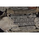 A BOX OF MIXED LACE Mostly narrow strips of edging, a mix of various cuffs and dress pieces. (
