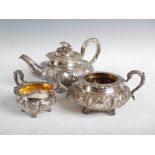 A William IV three piece silver tea set, London, 1830, makers mark of WH, of lobbed circular form