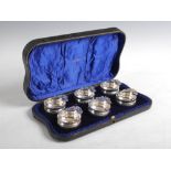 A cased set of six Edwardian silver wine tasters, London, 1906, makers mark of Fs.Ld. Finnigans Ltd,