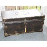 A 19th century leather covered and brass studded trunk, the hinged rectangular top centred with a