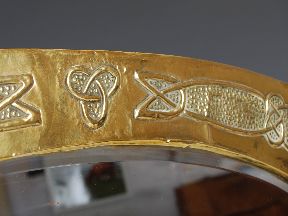 A Scottish Arts & Crafts brass wall mirror, the oval bevelled mirror plate within an embossed Celtic - Image 2 of 10