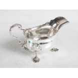 A George V silver sauce boat, Chester, 1911, makers mark of G.N over R.H, raised on three shell cast