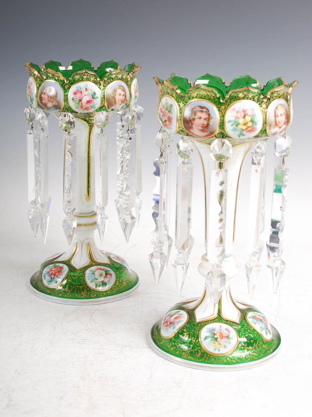 A pair of late 19th century Bohemian green and opaque white glass lustres, suspending clear glass