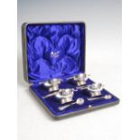 A cased set of four George V silver quaich form salts, London, two 1910, two 1911, makers mark of