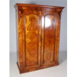 A Victorian walnut wardrobe, the moulded cornice above a pair of arched panel doors, enclosed by