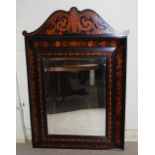 An ebonised and marquetry inlaid wall mirror in the Dutch style, with bevelled rectangular mirror