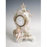 A late 19th century French porcelain Rococo style mantle clock, with circular Arabic and Roman