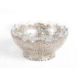 A Continental silver mounted cut glass bowl, pierced and cast with lattice shaped panels and