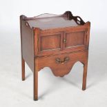 A George III mahogany tray top commode, the rectangular top with shaped gallery and pierced kidney