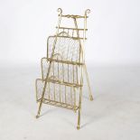 An early 20th century brass newspaper stand, of tapered rectangular form with three stepped
