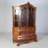 A 19th century Dutch walnut display cabinet, the domed top centred with a scroll and foliate