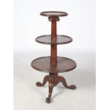 A 19th century mahogany three tier revolving whatnot, the upper tier supported on a Corinthian