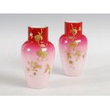 A pair of late 19th century Peach blow glass vases, with asymmetric gilded decoration of flowers and