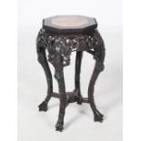 A Chinese dark wood octagonal shaped jardiniere stand, Qing Dynasty, the octagonal shaped top with