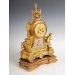 A late 19th century French ormolu and porcelain mounted mantle clock, the circular dial with