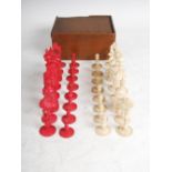 A late 19th century Anglo Indian carved and stained bone chess set, complete, in wooden box with