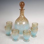 A rare Monart decanter and stopper with six liqueur glasses, mottled clear and pale blue glass