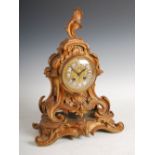 A late 19th century French Rococo style mantle clock, the circular dial with individual Roman