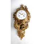 A 19th century French Rococo style ormolu cartel clock, the slightly convex white enamel dial with