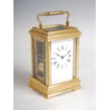 A late 19th/ early 20th century French repeating carriage clock, the white enamel dial with Roman