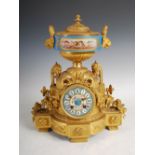 A late 19th century French ormolu and porcelain mounted mantle clock, the dial inscribed J.B.