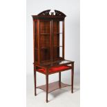 An Edwardian mahogany display cabinet in the George III style, the upright back with split